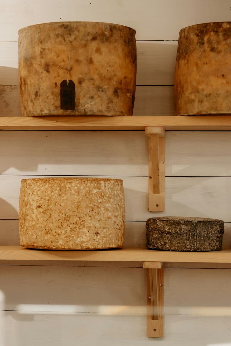 Large cheese wheels on a wooden board